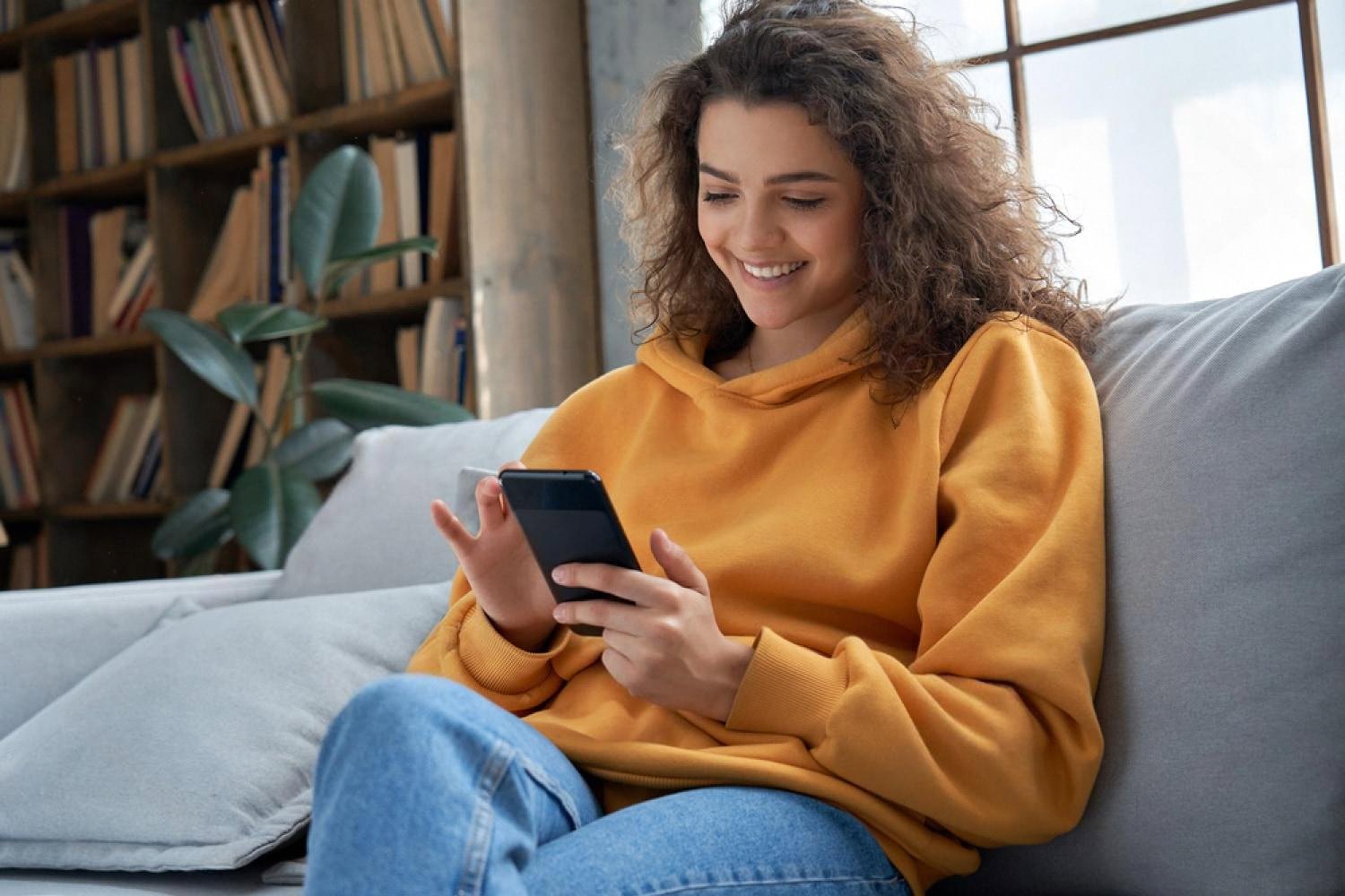 Young professional browsing online career training courses on a smartphone at home