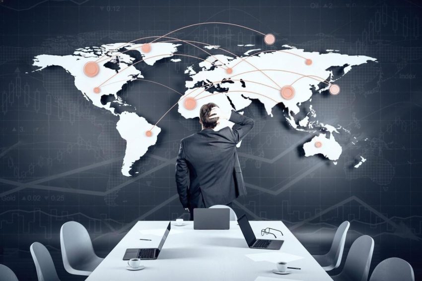 Businessman studying a world map of international trade connections